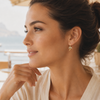 Woman wearing a delicate earring with a blurred background