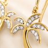 Gold earrings with diamond accents on a beige background