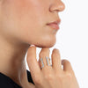 Close up of a woman wearing a white gold and diamond cuff-style ring