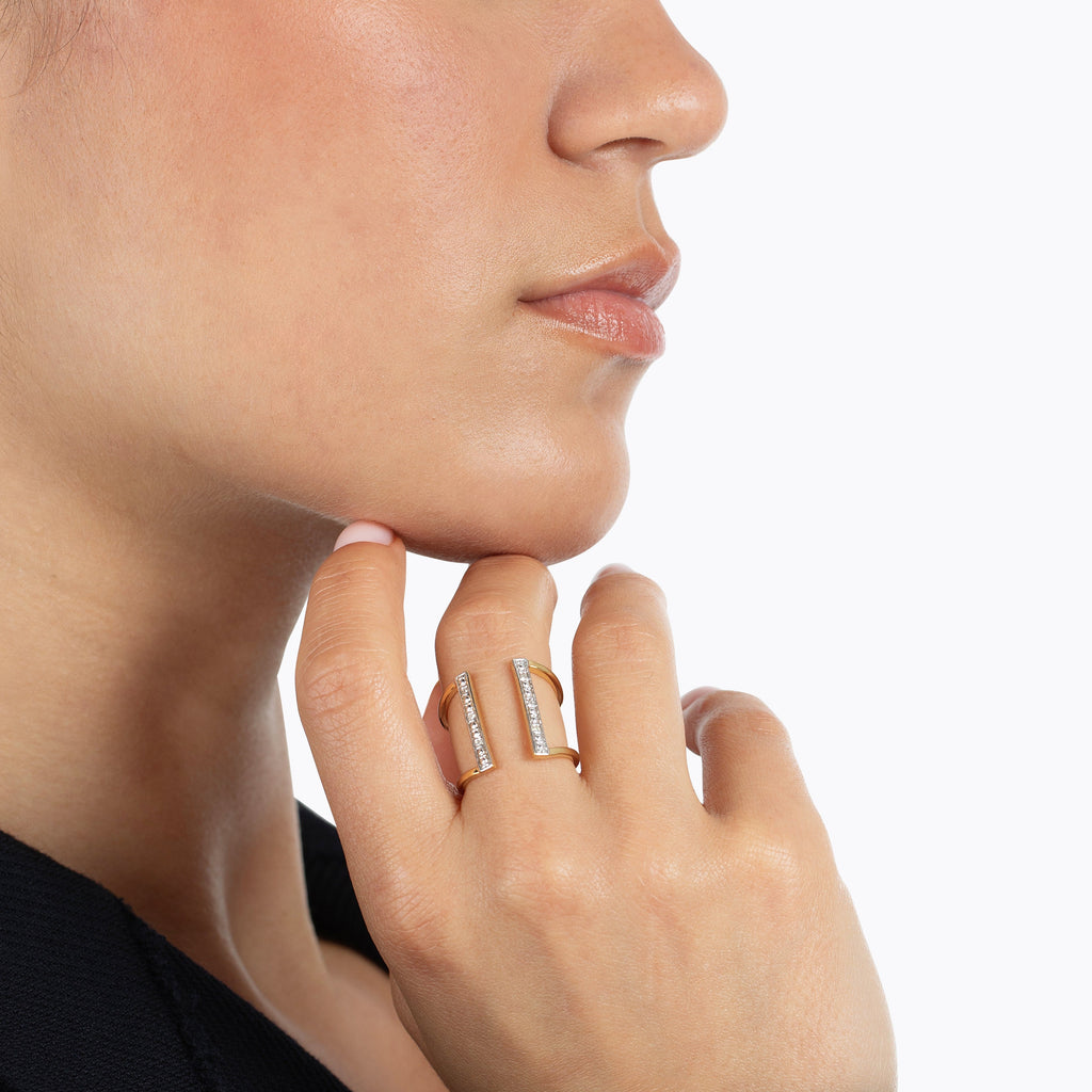 Close-up of a woman wearing a gold overlay and diamond cuff style-ring 