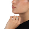 Close up of a woman wearing a silver and diamond cuff-style ring