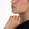 Close-up of a woman wearing a gold overlay and diamond cuff style-ring 